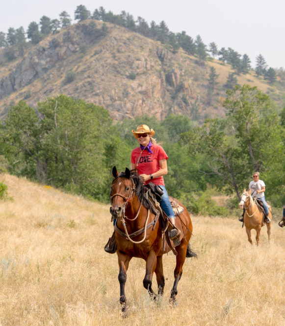 Sylvan Dale Rider on brown horse with mountain in backgrounds