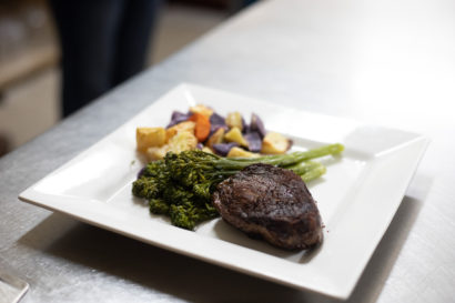 Small plate of food including broccoli, root vegetables and steak