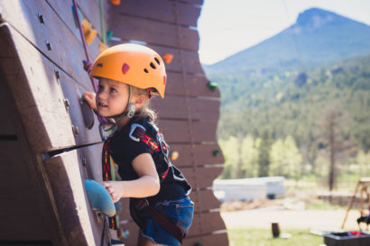 Child on a climbing wall wearing helmet