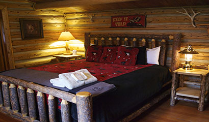 Covered Wagon Ranch Cabin with Red and Black Bed Spread and Towels
