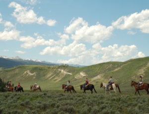 trail ride on ridge with blue sky and clouds