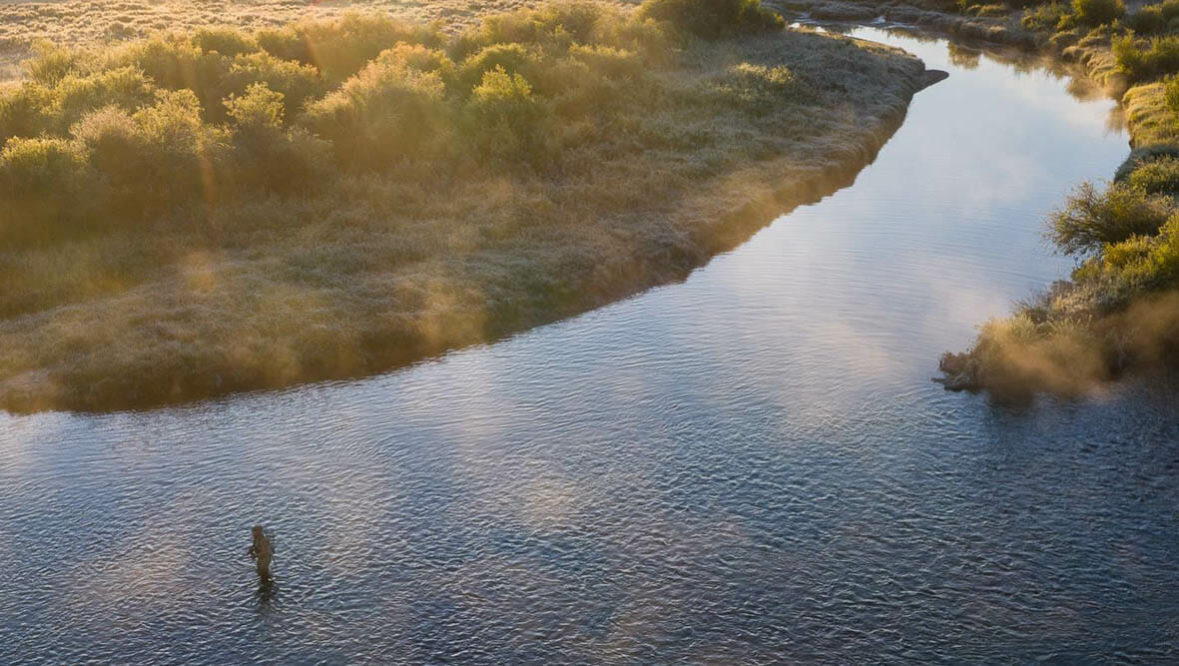 Drone shot of a guest fly fishing at A Bar A Ranch