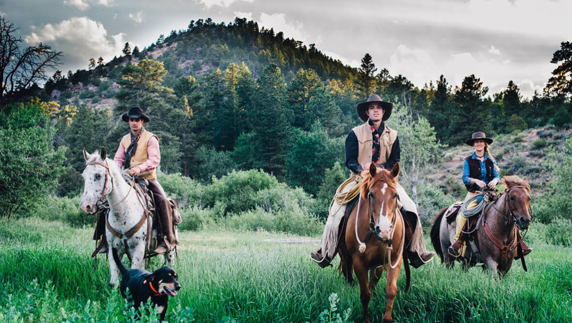Three guests on horses at Cherokee Park Ranch