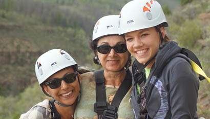 Three women with zip-lining helmets at Drowsy Water Ranch