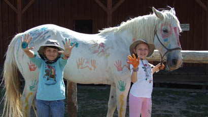 Kids painting a horse at Goosewing Ranch