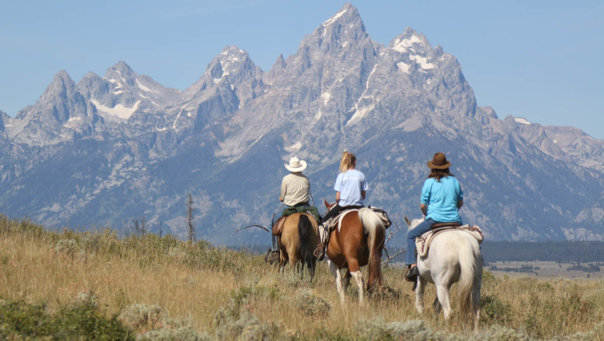 Trail ride with the Grand Tetons in the background at Moosehead Ranch