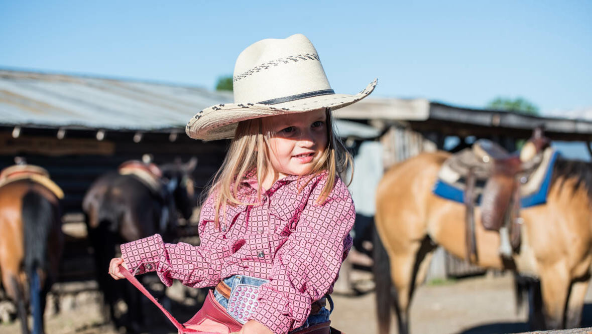 Little girl with cowboy hat on a horse at Parade Rest Ranch