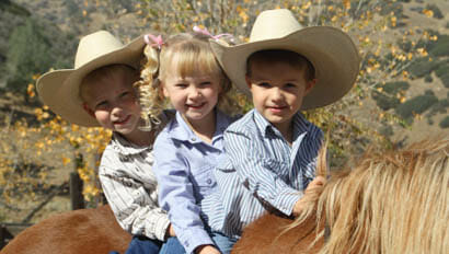 Three young kids on a horse at Rankin Ranch