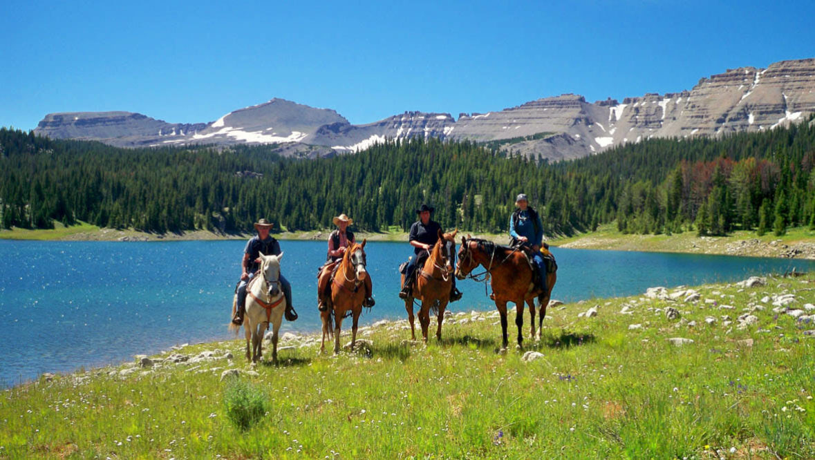 Family trail ride by a lake at Red Rock Lodge