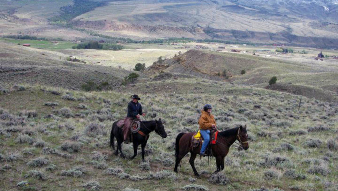 Two riders on a trail with a view at Rimrock Dude Ranch