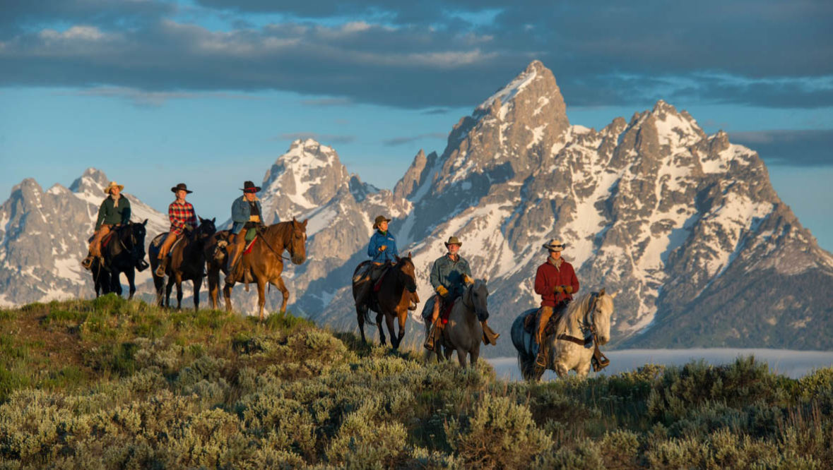 Trail ride with the Grand Tetons in the background at Triangle X Ranch