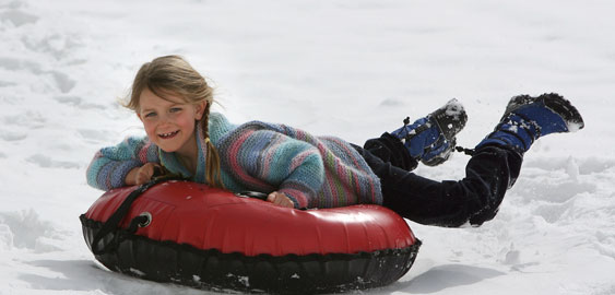 Girl snow tubing