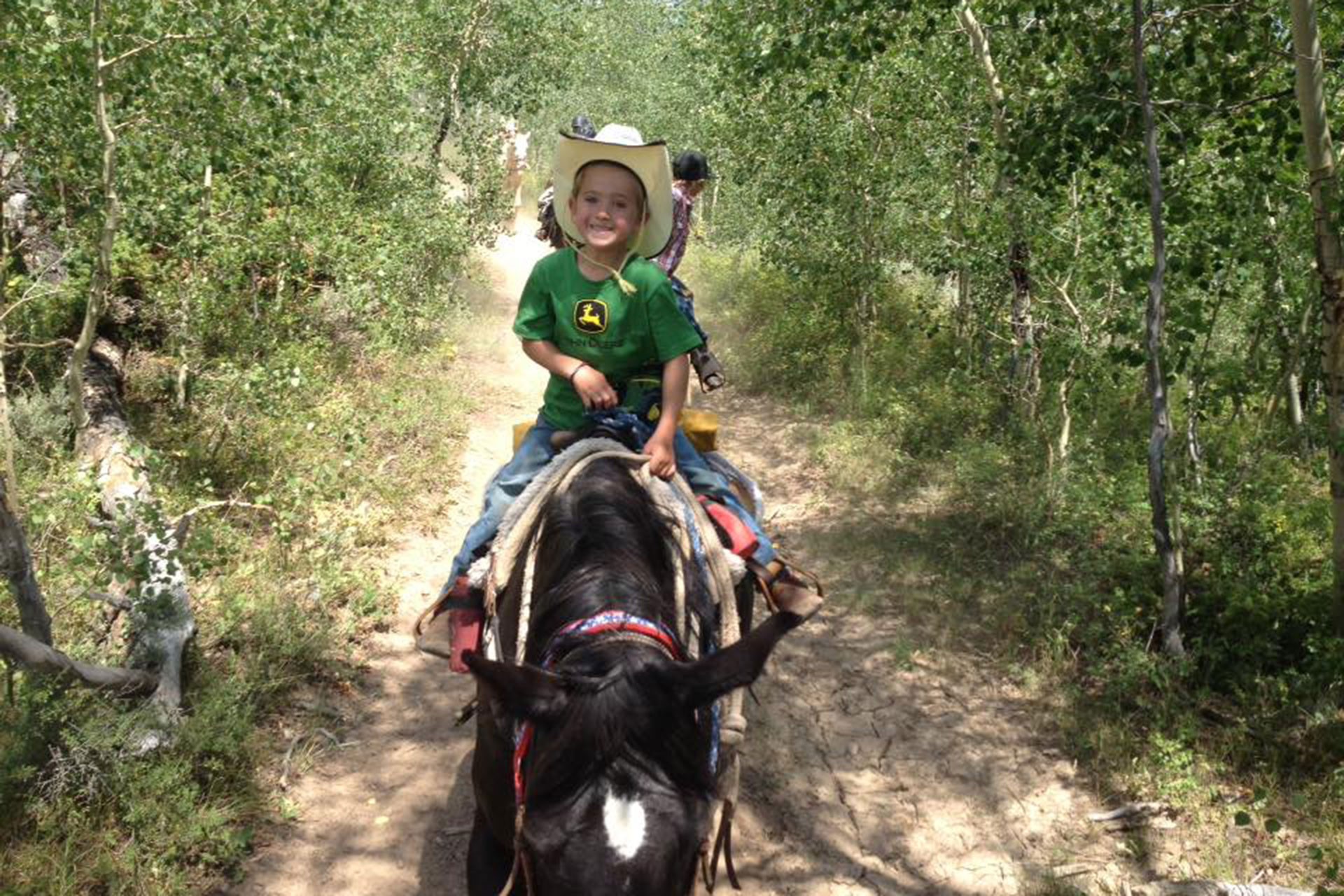 child riding a horse