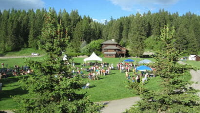 People gathered in front of the lodge for an event