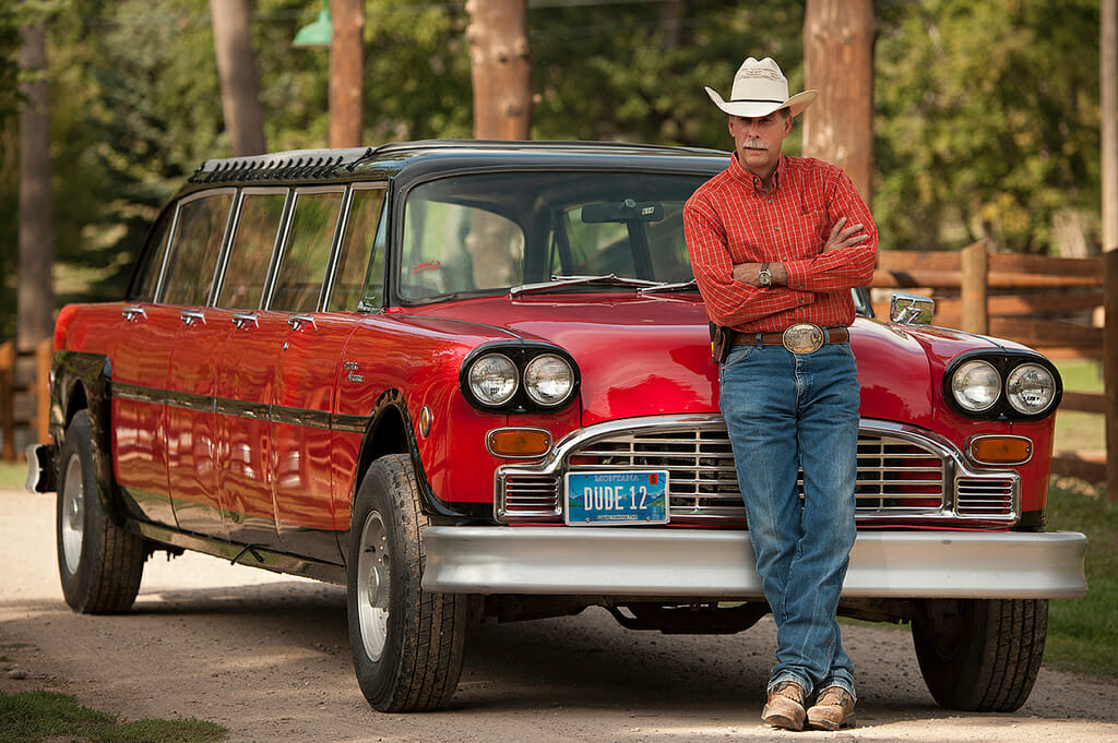 Cowboy in front of limo