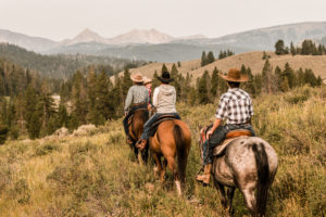 3 people riding horses